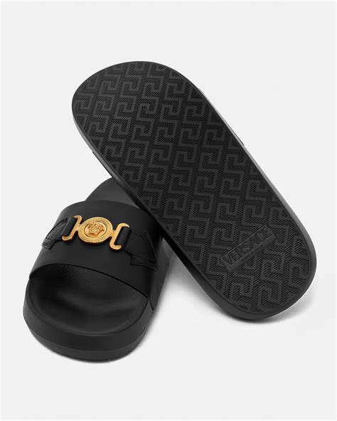 black versace slides with gold medusa